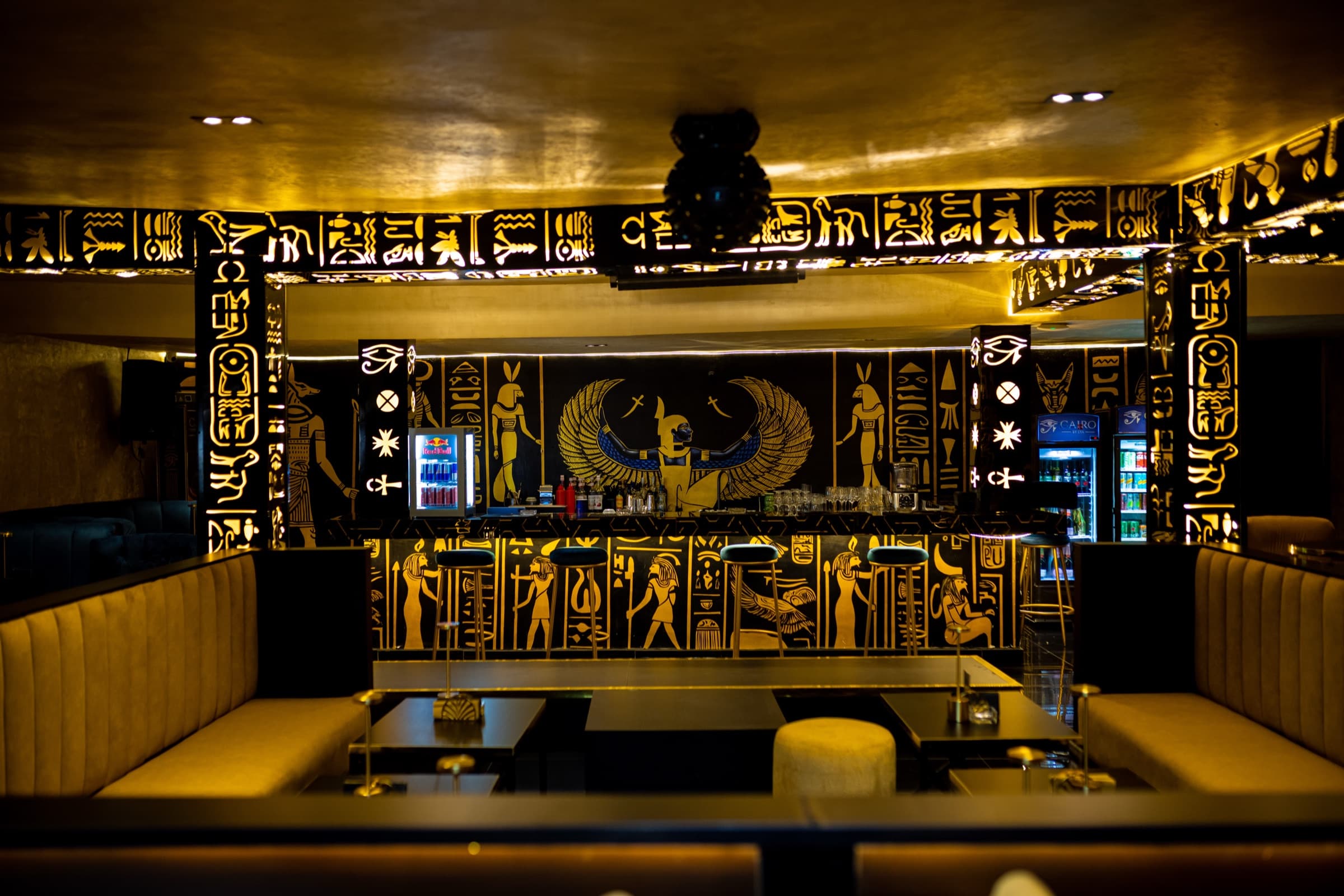 Cairo by LYA — the lounge, gold hieroglyph walls behind the bar